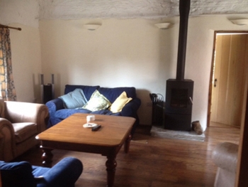 Apple Press Barn Sweethay sitting room view with log burning stove